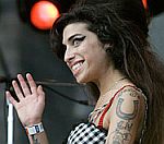 Wonky Winehouse Punches Fan At Glasto